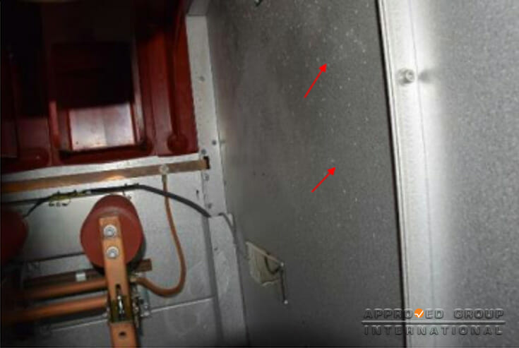 Figure 5: Whitish, powdery spots indicating condensation water marks were observed on the interior surfaces of cubicle panels (red arrows).